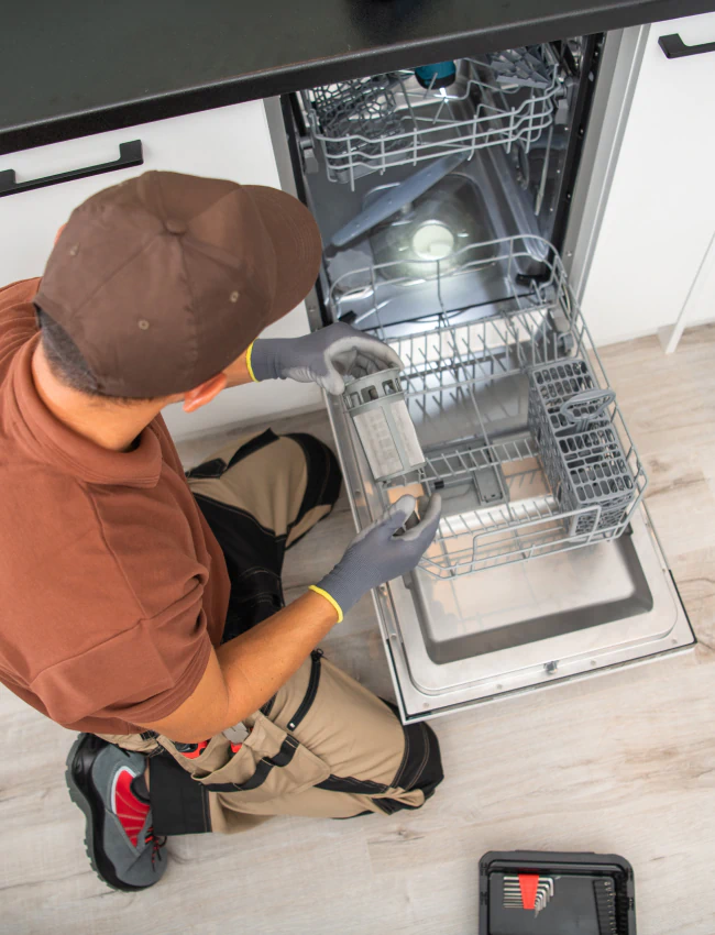 close up shot worker installing new dishwasher